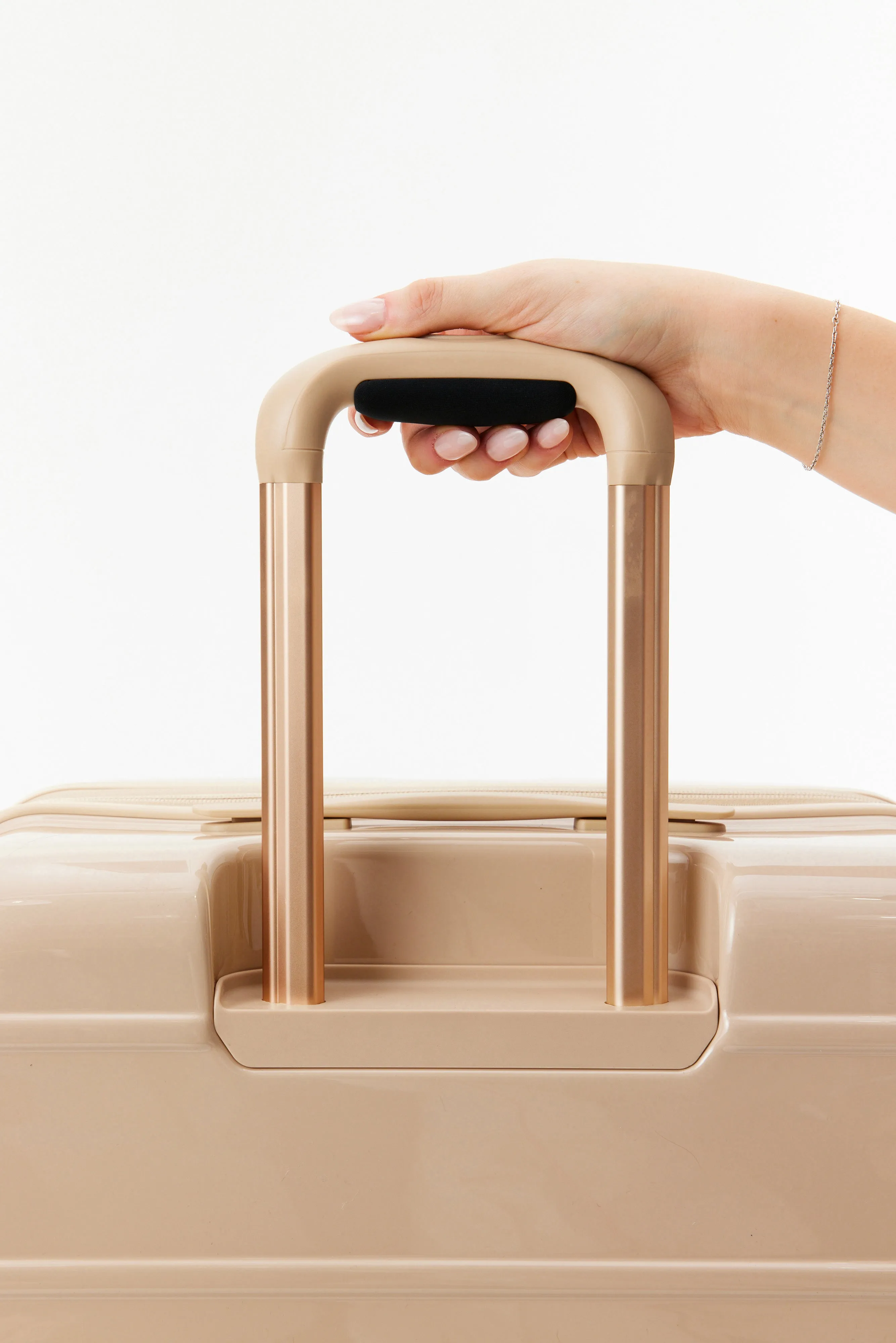 The Carry-On Roller in Glossy Beige